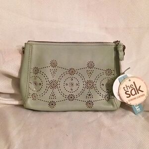 The sak.. light green clutch purse